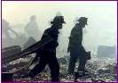 A group of firefighters walk amid rubble near the base of the destroyed World Trade Center in New York on September 11, 2001. Hundreds of firefighters and police are missing after two hijacked planes crashed into the Trade Center's twin towers a police source said. The source said there was an unconfirmed 265 firefighters and 85 police officers missing and feared dead. (Peter Morgan/Reuters)